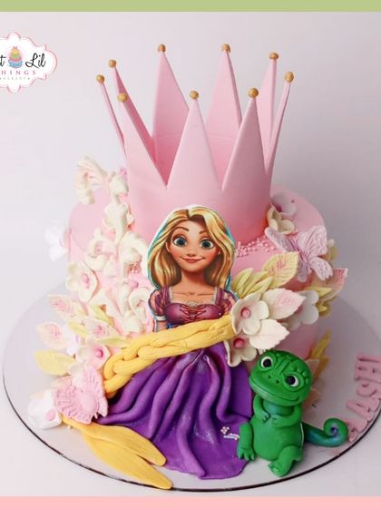 A cake fit for a princess! This Rapunzel-themed cake features the long-haired princess, her friend Pascal, and a large pink crown.