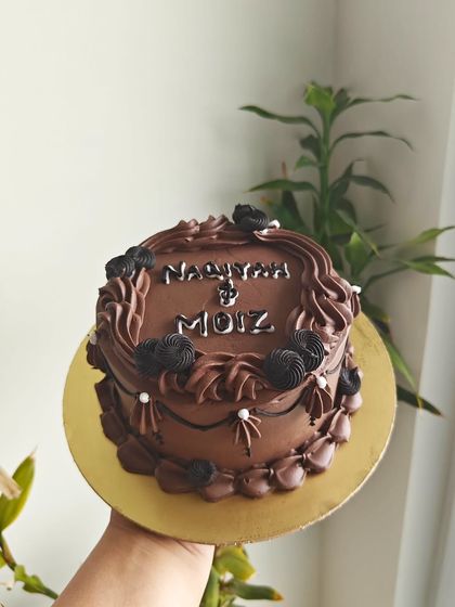 This vintage-style chocolate cake was for a couple's celebration. I used contrasting shades of chocolate buttercream for the piping and wrote their names on top.