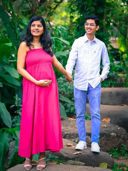 A casual and happy portrait of a couple holding hands on a stone path, enjoying their walk in the park.