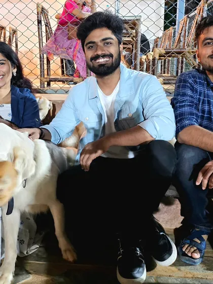 A group of friends enjoying their time at the park, surrounded by our friendly dogs.