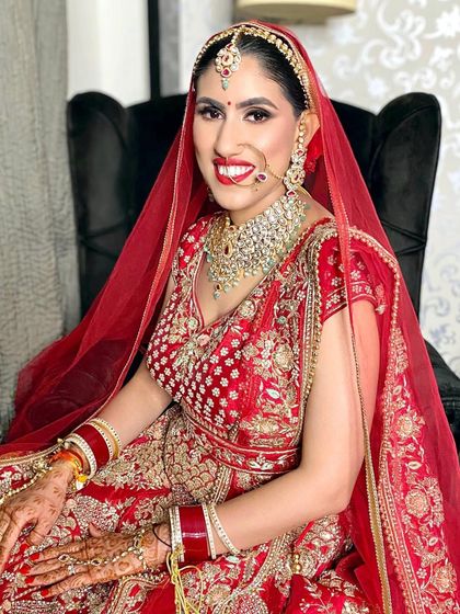 My UK bride looking stunning in a traditional red lehenga. We went for a classic look with a bright red lip and defined eyes.