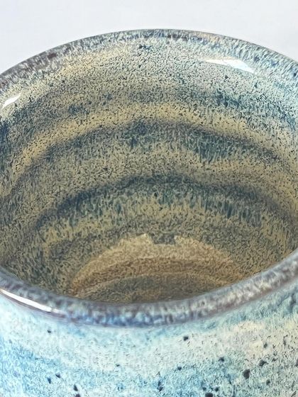 Looking into the blue goblet, you can see the throwing rings from the wheel, a subtle reminder of its handmade journey.