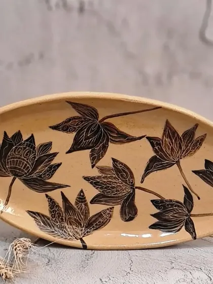 This special giant platter, measuring 13 inches, is a true statement piece. It is hand-painted with intricate lotus motifs and can be used to serve treats or as a decorative fruit bowl.