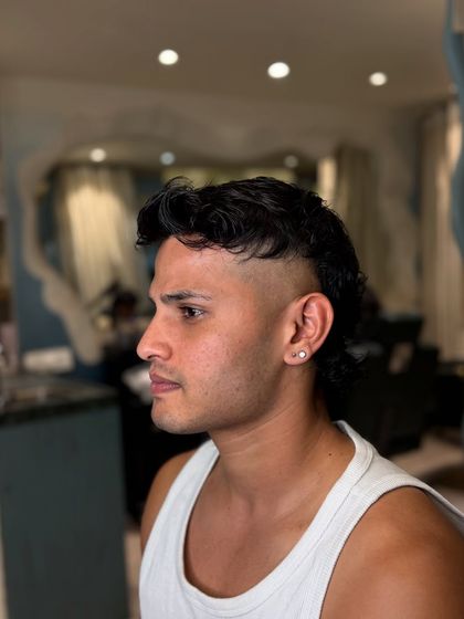 Ronaldo inspired locks. This is a modern mullet with a sharp fade on the sides, a popular look for footballers.