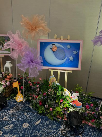 A decorated walkway with framed photos and whimsical props.