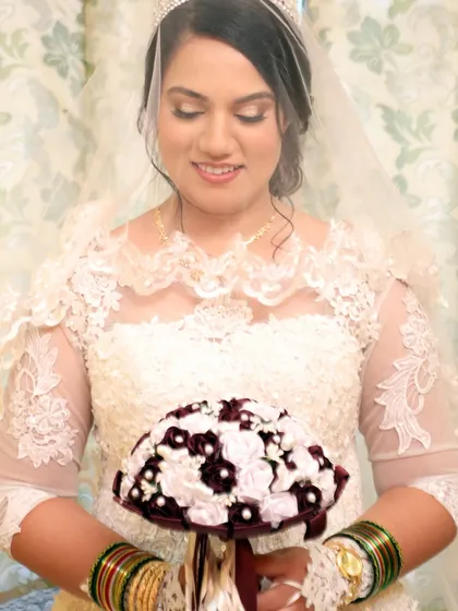 A lovely photo of the bride under her veil. The makeup is soft and romantic, designed to enhance her features without looking heavy.