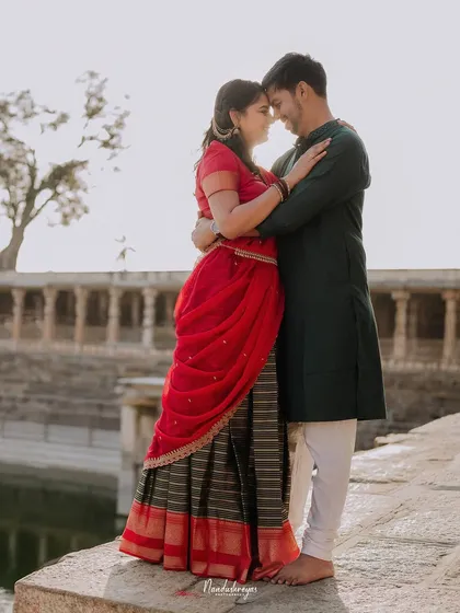 An intimate embrace by the temple pond, the soft light creating a serene and romantic atmosphere.