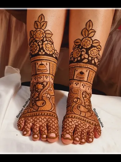 A traditional bridal feet design featuring peacocks and jhumkas. The rich, dense pattern is perfect for a bride who wants a classic look.