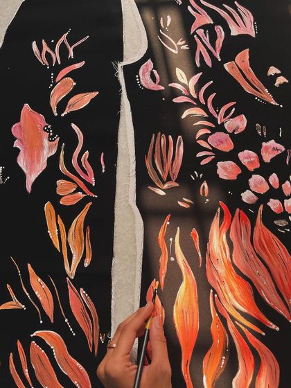 I loved painting these abstract fire patterns on a black velvet tuxedo. The contrast of the warm, fiery colors against the deep black fabric creates a powerful and dynamic design.