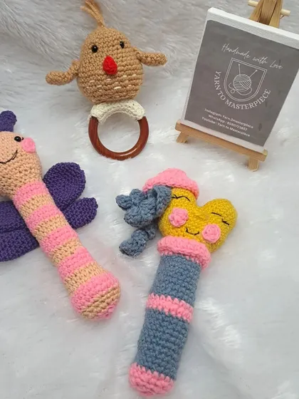 I offer a variety of handmade baby rattles. This collection shows a butterfly stick rattle, a chick teether rattle, and another colorful stick rattle.