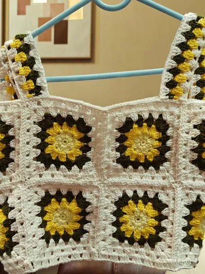 The sunflower crop top, ready to be shipped. Each square is carefully blocked and joined to create a clean, professional finish.