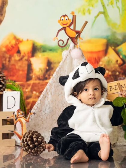 Sitting proudly in his panda costume, this one-year-old is the king of his own little jungle, complete with a teepee and pinecones.