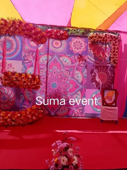 This vibrant setup was for a naming ceremony, but it's also perfect for a Haldi or Mehendi function. It includes a colorful mandala-print backdrop, bright pink and yellow drapes, and a custom floral swing for the perfect photo opportunity.