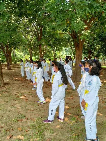 Students maintaining their ready stance ('Chunbi') while waiting for the next command. Discipline is practiced in every moment.