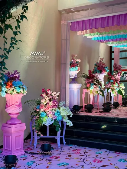 A side view of the entrance decor, showing the lush floral arrangements and the transition from the outdoors in.