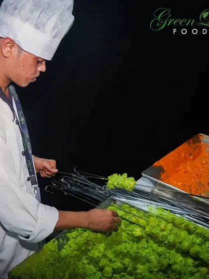 Our chefs are skilled in the art of tandoor cooking. Here, they are preparing marinated vegetable and paneer skewers, ready to be cooked in the hot tandoor for that classic smoky flavor.