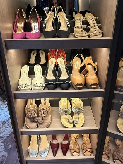 A close-up of a beautifully lit shoe display, featuring heels, wedges, and flats. We organize by type and color to create a visually pleasing and practical system.