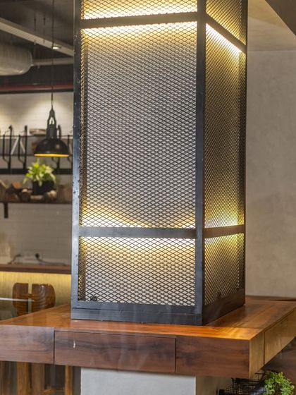 Rustic charm meets modern design in my restaurant, with industrial lighting and wooden elements creating a unique ambiance.