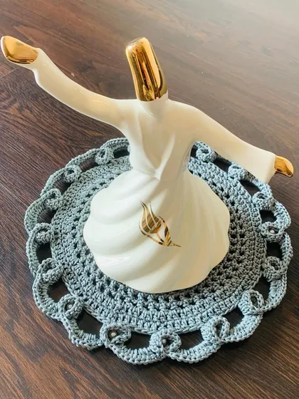 For a more classic and elegant look, I designed this intricate grey lacy doily. It’s perfect for placing under a special showpiece, like this whirling dervish statue, to give it a beautiful, handcrafted base.