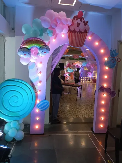 Another view of the glowing Candyland entrance arch. The internal lights make the structure pop, especially in an indoor venue, guiding guests into the party zone.