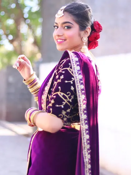 A beautiful reception look in a rich purple velvet saree, perfect for a winter wedding.