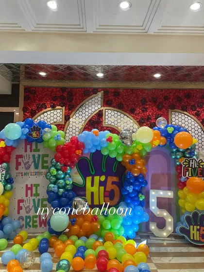 Another angle of the vibrant 'Hi-5' party decorations. The balloon arrangement uses a mix of red, blue, green, yellow, and orange to create a playful and high-energy look.