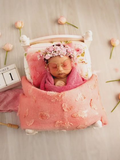 This whimsical setup tells a story, complete with a date block, a tiny parasol, and butterflies. It's a perfect example of a personalized, prop-heavy theme to celebrate a birth date.