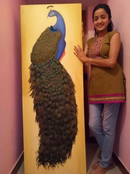 Here I am with a large-scale custom peacock painting, standing over five feet tall. I love working on big canvases to create a truly immersive piece of nature-inspired art. The texture in the feathers and the bold gold background make it a centerpiece in any room.