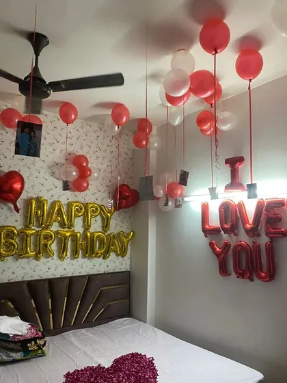 Another angle of this popular birthday and anniversary room setup. You can see how the photos hanging from the ceiling balloons add a wonderful personal touch to the celebration.