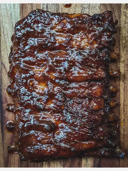 A close-up of my Barbeque Pork Ribs, showing the glistening, caramelized homemade sauce coating the entire rack.