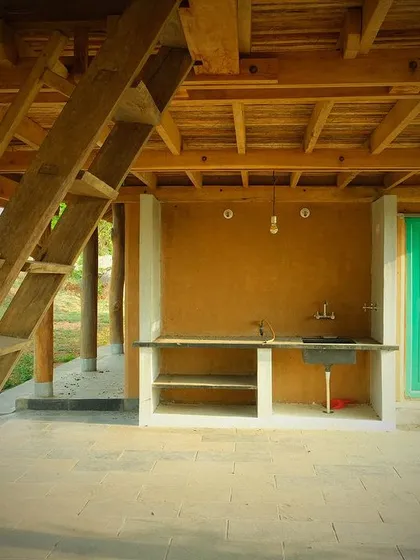 A basic yet functional outdoor kitchen space at the Unnathi Farm pavilion, perfect for a rural retreat.