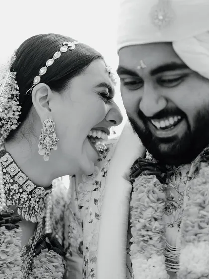 The purest form of joy captured in a timeless black and white frame. This candid photograph of the couple's unrestrained laughter during their wedding ceremony is a perfect example of the unscripted, real moments I strive to capture.