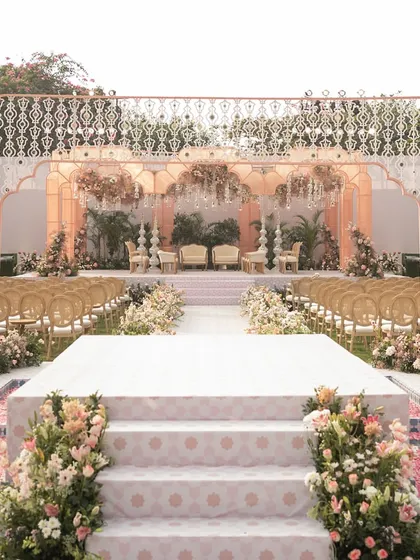 A head-on view of the aisle leading to the mandap, showing the water channels on either side. The design is inspired by the formal layouts of royal Mughal gardens.