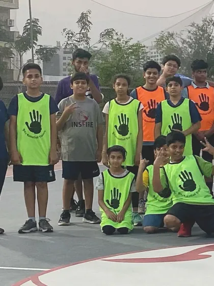 The Unity Basketball team with their coach, showing the spirit of sportsmanship and friendly competition.