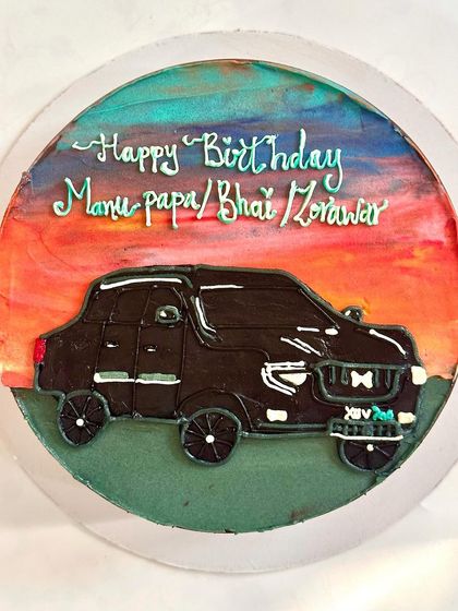 A custom cake featuring a hand-painted XUV 700 against a sunset sky. We use different buttercream colors and textures to create a dynamic background for our illustrations.