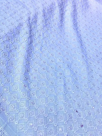 A classic light blue Chikankari material with delicate white embroidery. This fabric makes for a sophisticated and comfortable kurta suitable for any traditional gathering.