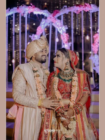 A beautiful portrait of Nikhil and Srishti under a canopy of purple and white lights, their loving gaze telling a story of its own.