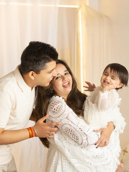 Pure, unscripted laughter. This candid shot captures the genuine joy and connection between parents and their child.