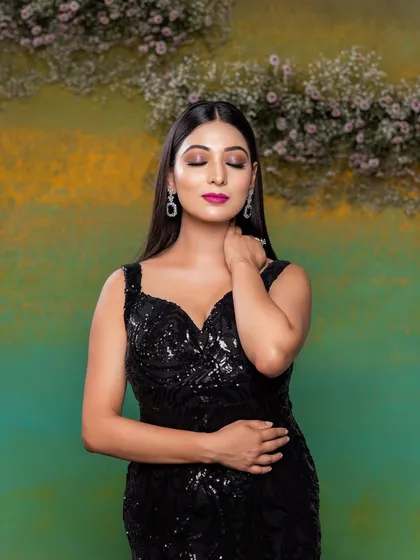 A dramatic pose from a portfolio shoot. The makeup is all about glamour, with a bold fuchsia lip and expertly blended smokey eyeshadow on a flawless base.