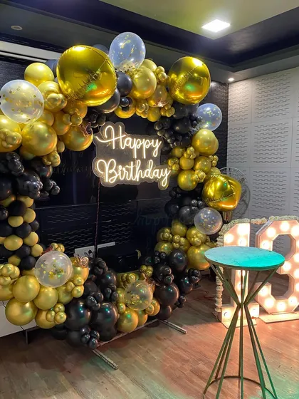 The black and gold theme creates a sophisticated atmosphere for a teenager's birthday party.