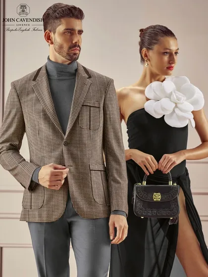 Another look from the Vicky Tailors campaign. The female model features a classic red lip and a sleek updo, while the male model's grooming is impeccable, creating a sophisticated and timeless pairing.