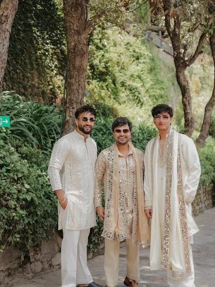 We designed these coordinated ethnic outfits for YouTuber Triggered Insaan and his friends. The looks feature a mix of mirror work and subtle embroidery in a complementary off-white and beige palette, perfect for a daytime wedding event.