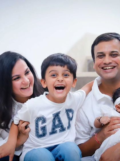 Pure family joy. This candid shot captures a huge laugh from the big brother during their outdoor family session.