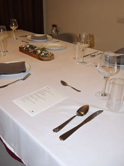 A close-up of the table, ready for guests. Fine cutlery, proper glassware, and a custom menu are all part of the comprehensive private chef service I provide.