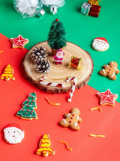 An assortment of our hand-decorated Christmas cookies, including Santa faces, bells, stars, and gingerbread men.