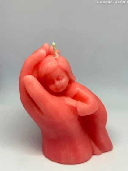 A flame cradled with love. This candle captures the warmth of a mother's hands and the innocence of a child, a truly special piece.