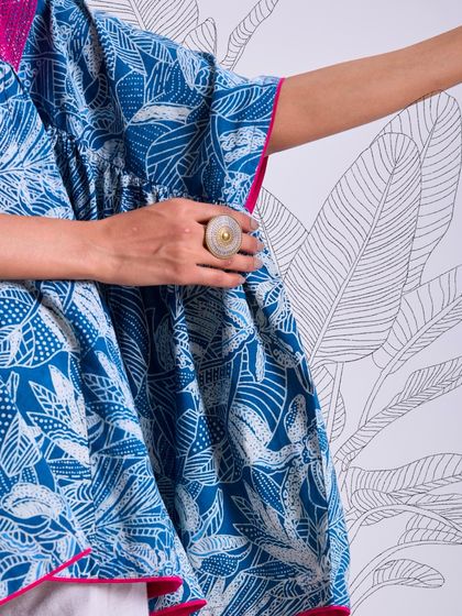 A detail shot of the side of our Chaaya oversized top, showing the beautiful drape of the fabric and the intricate block print. It's a celebration of natural materials and handcrafted skill.