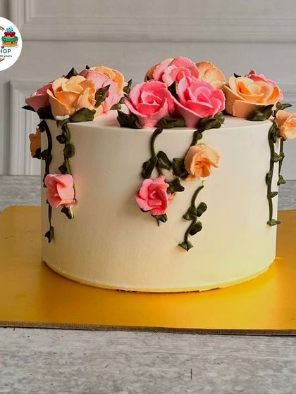 A simple yet beautiful cake featuring a cascade of hand-piped buttercream roses in shades of pink and peach. This design showcases our skill in classic cake decorating techniques.