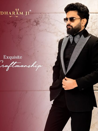 A model wearing a black tuxedo with stunning silver-studded lapels. This is the epitome of exquisite craftsmanship and modern luxury.