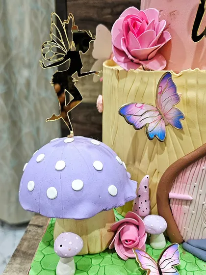 A close-up of the tiny fairy silhouette and butterfly decorations.